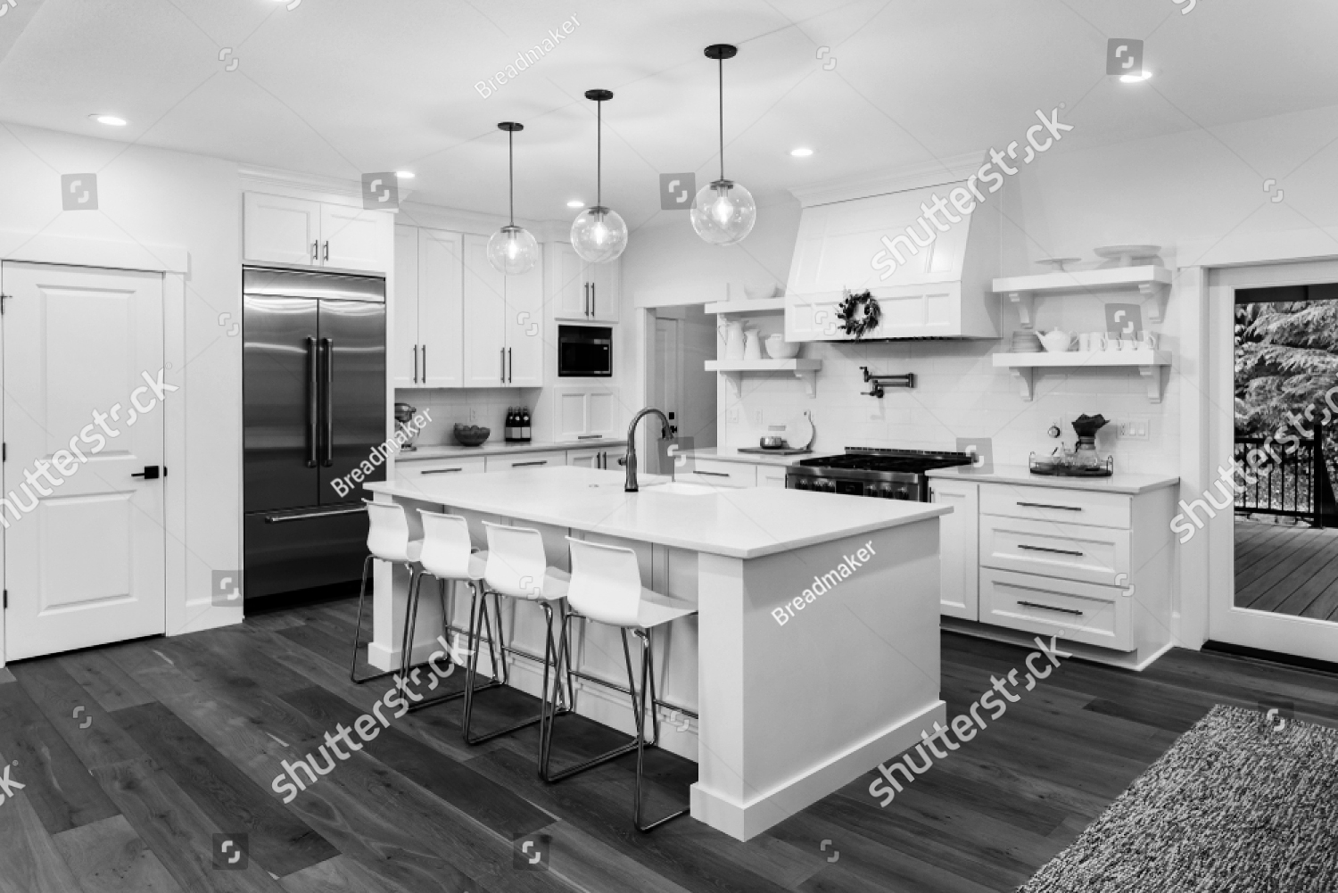 stock-photo-beautiful-white-kitchen-in-new-luxury-home-with-island-pendant-lights-hardwood-floors-and-1213273798_bw